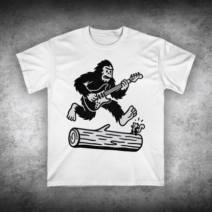 White t-shirt with a graphic of a gorilla playing guitar on a concrete surface