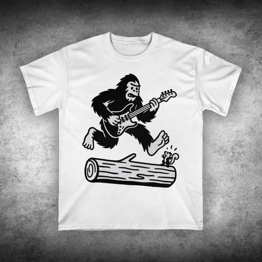 White t-shirt with a graphic of a gorilla playing guitar on a concrete surface