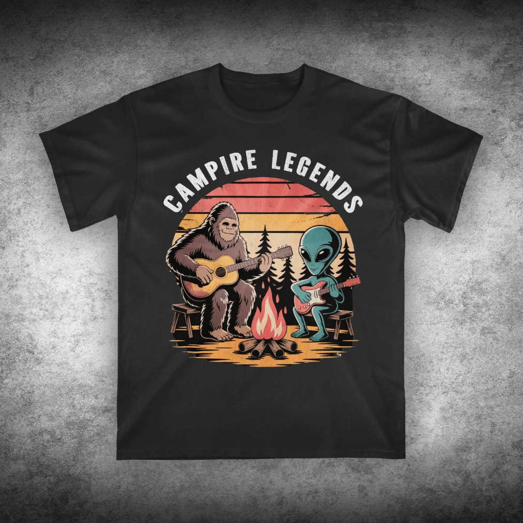 Black t-shirt with 'Campire Legends' graphic featuring a bear and alien by a campfire on a textured gray background.