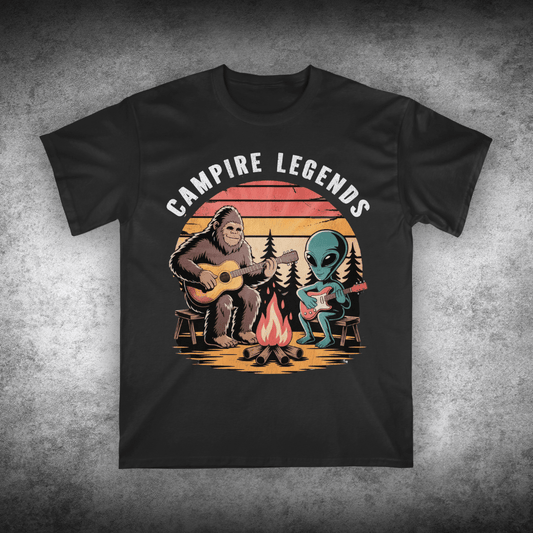 Black t-shirt with 'Campire Legends' graphic featuring a bear and alien by a campfire on a textured gray background.
