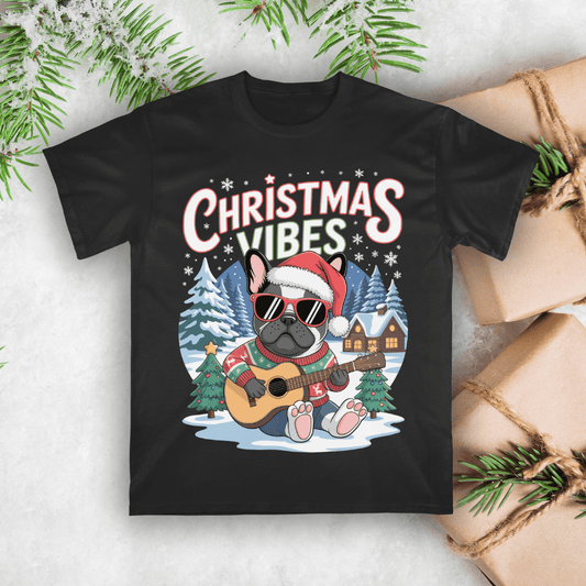 Black t-shirt with a Christmas-themed design featuring a dog playing guitar and text 'Christmas Vibes' on a snowy background.