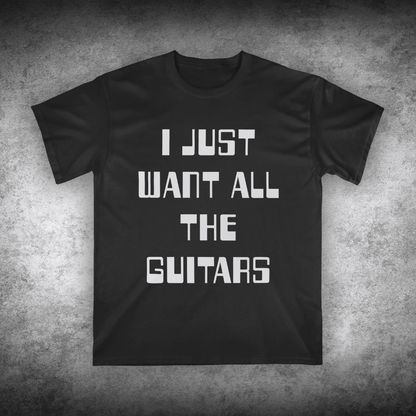 Black t-shirt with white text 'I JUST WANT ALL THE GUITARS' on a textured gray background