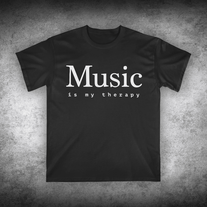 Black t-shirt with 'Music is my therapy' text on a textured gray background
