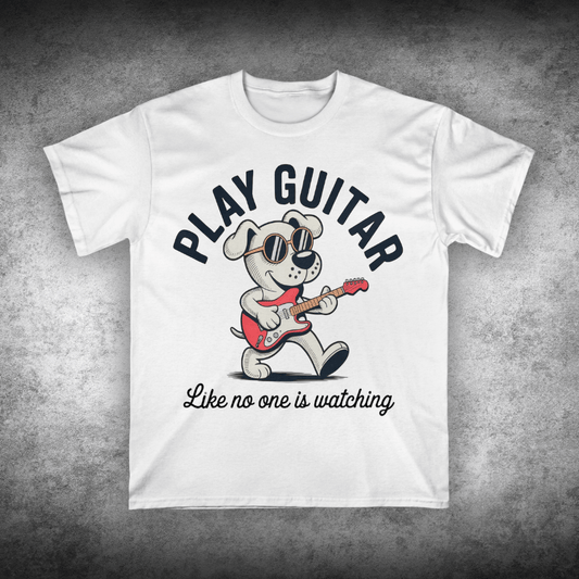 White t-shirt with a cartoon dog playing guitar and text on a textured gray background