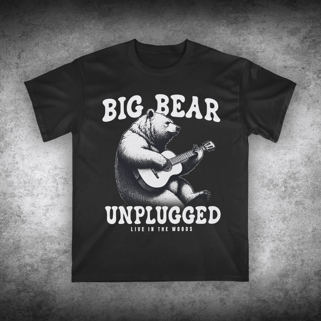 Black t-shirt with a bear playing guitar graphic and text on a textured gray background