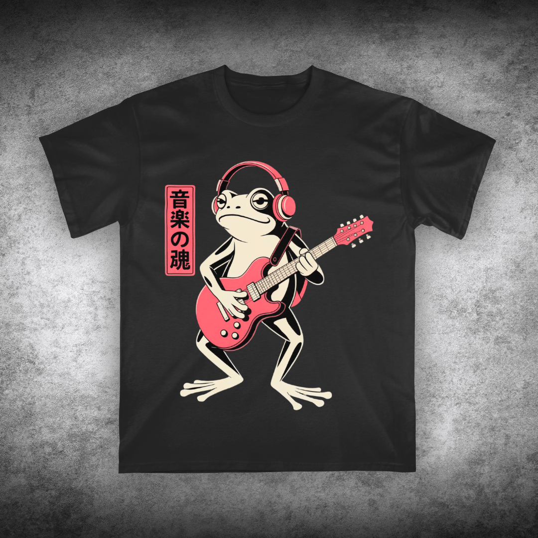 Black t-shirt with a frog playing a red guitar and wearing headphones design on a textured gray background.