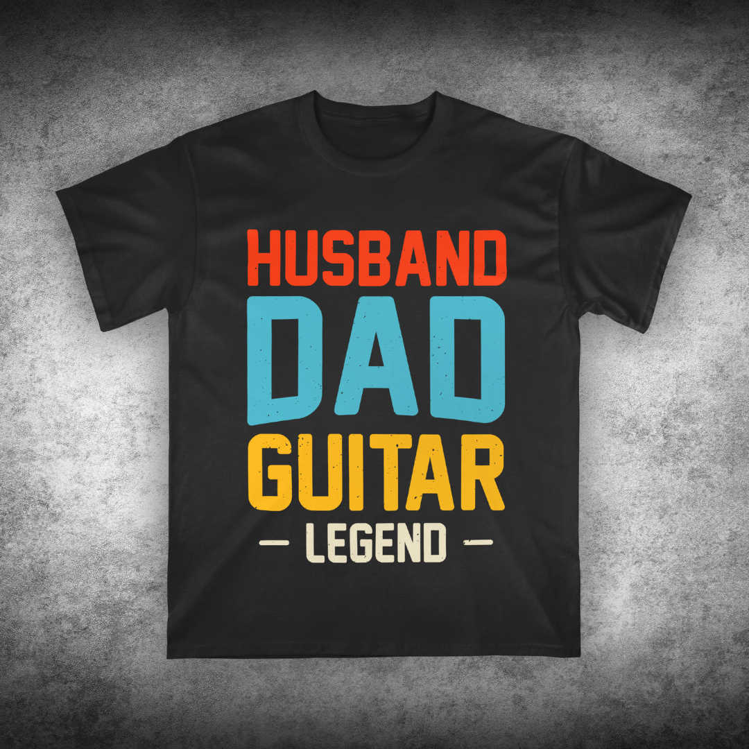Black t-shirt with colorful text 'Husband Dad Guitar Legend' on a textured gray background