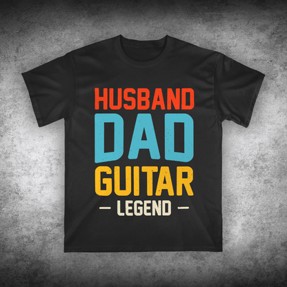 Black t-shirt with colorful text 'Husband Dad Guitar Legend' on a textured gray background
