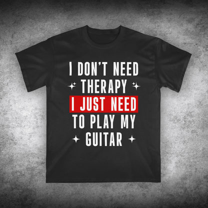 Black t-shirt with text 'I don't need therapy, I just need to play my guitar' on a textured gray background
