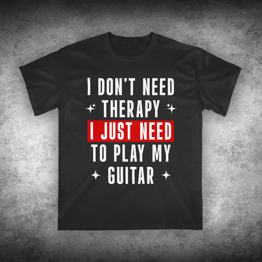Black t-shirt with text 'I don't need therapy, I just need to play my guitar' on a textured gray background