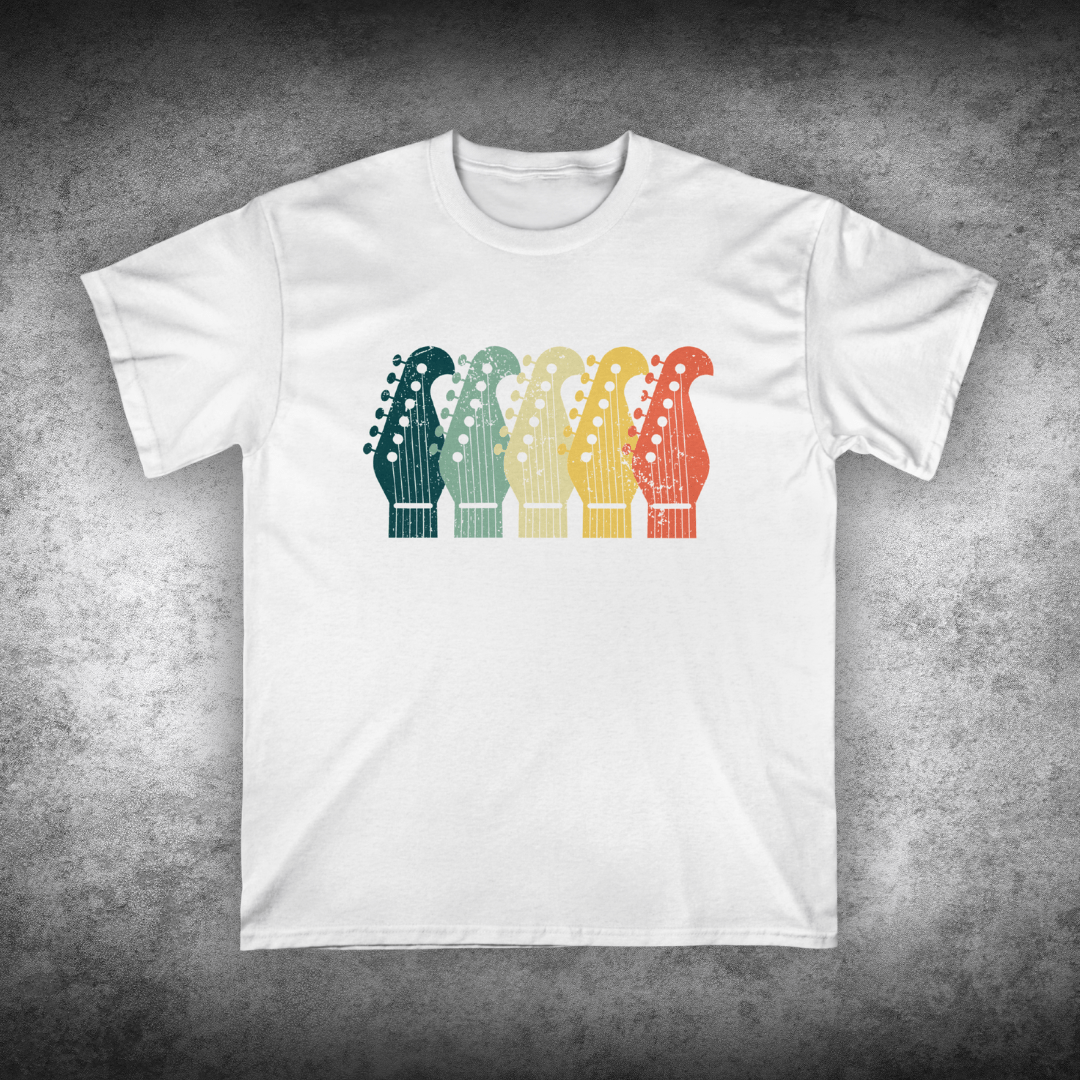 White t-shirt with colorful guitar headstock design on a textured gray background